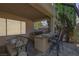 Covered outdoor kitchen with bar seating and built-in grill at 7872 Regency Park St, Las Vegas, NV 89149