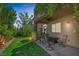 Relaxing covered patio with lush landscaping and a seating area at 7872 Regency Park St, Las Vegas, NV 89149