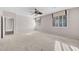 Large bedroom with plush carpet, ceiling fan and many windows at 805 Dana Hills Ct # 104, Las Vegas, NV 89134