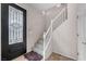 Entryway with decorative door and staircase featuring carpeted stairs and white railings at 805 Dana Hills Ct # 104, Las Vegas, NV 89134
