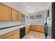 Practical kitchen with light wood cabinets, black appliances, and tiled backsplash at 805 Dana Hills Ct # 104, Las Vegas, NV 89134
