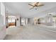Spacious living area with a ceiling fan, large windows, and an archway to the kitchen at 805 Dana Hills Ct # 104, Las Vegas, NV 89134