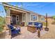 Charming back patio featuring a stone fire pit, comfortable seating, and mature plants for outdoor enjoyment at 8058 Big Skye Ranch St, Las Vegas, NV 89166