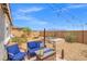 Spacious backyard featuring a hot tub, fire pit, and comfortable seating, perfect for relaxing and enjoying the outdoors at 8058 Big Skye Ranch St, Las Vegas, NV 89166