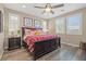 Bright bedroom featuring wood floors, neutral paint, and a large bed with patterned bedding at 8058 Big Skye Ranch St, Las Vegas, NV 89166