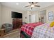 Bedroom showcasing hardwood floors, a TV, and a walk-in bathroom at 8058 Big Skye Ranch St, Las Vegas, NV 89166