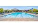 Sparkling community pool with clear lanes and lounge chairs, perfect for relaxation and exercise at 8058 Big Skye Ranch St, Las Vegas, NV 89166