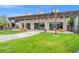 Inviting exterior patio with pergola, seating area, and view of the lush lawn at 8058 Big Skye Ranch St, Las Vegas, NV 89166