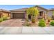 Charming single-story home featuring a well-manicured yard, a two-car garage and stone accents at 8058 Big Skye Ranch St, Las Vegas, NV 89166