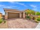 Charming single-story home with desert landscaping, a paved driveway, and stone facade accents at 8058 Big Skye Ranch St, Las Vegas, NV 89166