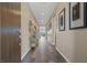 Hallway featuring hardwood floors and decorative framed art hanging on the walls at 8058 Big Skye Ranch St, Las Vegas, NV 89166