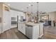 Open kitchen with large island, stainless appliances, and view into the dining and living areas at 8058 Big Skye Ranch St, Las Vegas, NV 89166