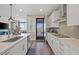 Modern kitchen with stainless appliances, white cabinetry and an open layout, with easy access to outdoor patio at 8058 Big Skye Ranch St, Las Vegas, NV 89166