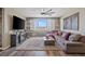 Comfortable living room with a sectional sofa, television, and wood-look accent wall at 8058 Big Skye Ranch St, Las Vegas, NV 89166