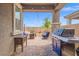 Relaxing covered patio with a barbecue grill and outdoor seating area, perfect for entertaining and enjoying the outdoors at 8058 Big Skye Ranch St, Las Vegas, NV 89166