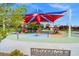 Community playground with colorful shade structures, climbing frames, and play equipment for ' enjoyment at 8058 Big Skye Ranch St, Las Vegas, NV 89166