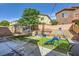 Lush backyard featuring a trampoline, swing set, and playground at 8091 Mosaic Sunrise Ln, Las Vegas, NV 89166