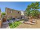 Inviting backyard with manicured landscaping, stone accents, lawn, trampoline and swing set at 8091 Mosaic Sunrise Ln, Las Vegas, NV 89166
