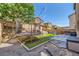 Inviting backyard featuring a trampoline, swing set, grill and ample recreational opportunities at 8091 Mosaic Sunrise Ln, Las Vegas, NV 89166