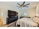Bedroom with ceiling fan and dresser with television and view of walk in closet at 8091 Mosaic Sunrise Ln, Las Vegas, NV 89166