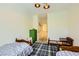 Bright bedroom showcasing two twin beds, a plaid rug, and a playful green dresser at 8091 Mosaic Sunrise Ln, Las Vegas, NV 89166