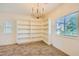 Bright bedroom features custom built-in shelving and two windows for great natural light at 8091 Mosaic Sunrise Ln, Las Vegas, NV 89166
