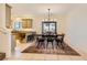 Bright dining area featuring a modern chandelier and seating for six, seamlessly connected to the kitchen at 8091 Mosaic Sunrise Ln, Las Vegas, NV 89166