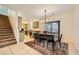 Charming dining area with easy access to the carpeted stairs and open flow to the kitchen at 8091 Mosaic Sunrise Ln, Las Vegas, NV 89166