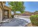 Expansive driveway with mature landscaping and a private, gated front porch area at 8091 Mosaic Sunrise Ln, Las Vegas, NV 89166
