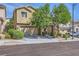 Two-story home with a two-car garage, a mature shade tree and manicured landscaping at 8091 Mosaic Sunrise Ln, Las Vegas, NV 89166