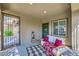 Cozy covered front porch featuring comfortable seating, a water feature, and stylish decor at 8091 Mosaic Sunrise Ln, Las Vegas, NV 89166
