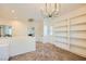 Bright hallway features a chandelier, built-in bookcase and access to multiple rooms at 8091 Mosaic Sunrise Ln, Las Vegas, NV 89166