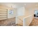 Upstairs hallway featuring a built-in bookcase and chandelier providing a functional and bright space at 8091 Mosaic Sunrise Ln, Las Vegas, NV 89166