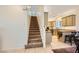 View of kitchen with granite countertops and view of staircase with carpet flooring at 8091 Mosaic Sunrise Ln, Las Vegas, NV 89166