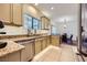 Beautiful kitchen with granite counters, a stainless dishwasher, and seamless access to the dining area at 8091 Mosaic Sunrise Ln, Las Vegas, NV 89166