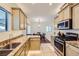 Bright kitchen with granite counters, stainless appliances, and ample counter space, perfect for cooking at 8091 Mosaic Sunrise Ln, Las Vegas, NV 89166