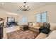 Open-concept living area with tile floors, comfortable seating, and a dining area in the background at 8091 Mosaic Sunrise Ln, Las Vegas, NV 89166