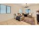 Inviting living room featuring tile floors, natural light, and comfortable seating arrangement at 8091 Mosaic Sunrise Ln, Las Vegas, NV 89166