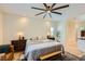 Bedroom with a ceiling fan, window, and bench with view of bathroom at 8091 Mosaic Sunrise Ln, Las Vegas, NV 89166