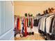 Walk-in closet containing shelves of clothing and shoes at 8091 Mosaic Sunrise Ln, Las Vegas, NV 89166