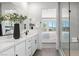 Bright bathroom featuring double vanity with quartz countertop and a glass-enclosed shower at 84 Via Franello, Henderson, NV 89011