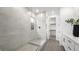 Modern bathroom featuring a glass shower, white cabinets, and a view of the walk-in closet at 84 Via Franello, Henderson, NV 89011