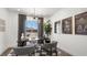 Bright home office with modern lighting, sleek black desk, neutral chairs, and framed artwork at 84 Via Franello, Henderson, NV 89011