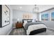 Serene main bedroom featuring a modern chandelier, stylish decor, and carpet floors at 84 Via Franello, Henderson, NV 89011