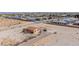 Property aerial shot featuring a cozy home, paved driveway, and desert vegetation at 8430 Gagnier Blvd, Las Vegas, NV 89113