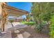 Landscaped backyard with covered patio and lush greenery with beautiful mountain views at 8840 Arroyo Azul St, Las Vegas, NV 89131