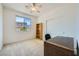 Bright bedroom featuring a ceiling fan, closet and a view of the outdoors at 8840 Arroyo Azul St, Las Vegas, NV 89131
