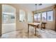 Charming dining area featuring arched doorways, natural light, and a neutral color palette, adjacent to the living room at 8840 Arroyo Azul St, Las Vegas, NV 89131