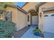 Welcoming entryway with a covered porch and decorative potted plants leading to the front door at 8840 Arroyo Azul St, Las Vegas, NV 89131