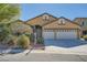 Inviting single-story home with a well-manicured front yard and a two-car garage at 8840 Arroyo Azul St, Las Vegas, NV 89131